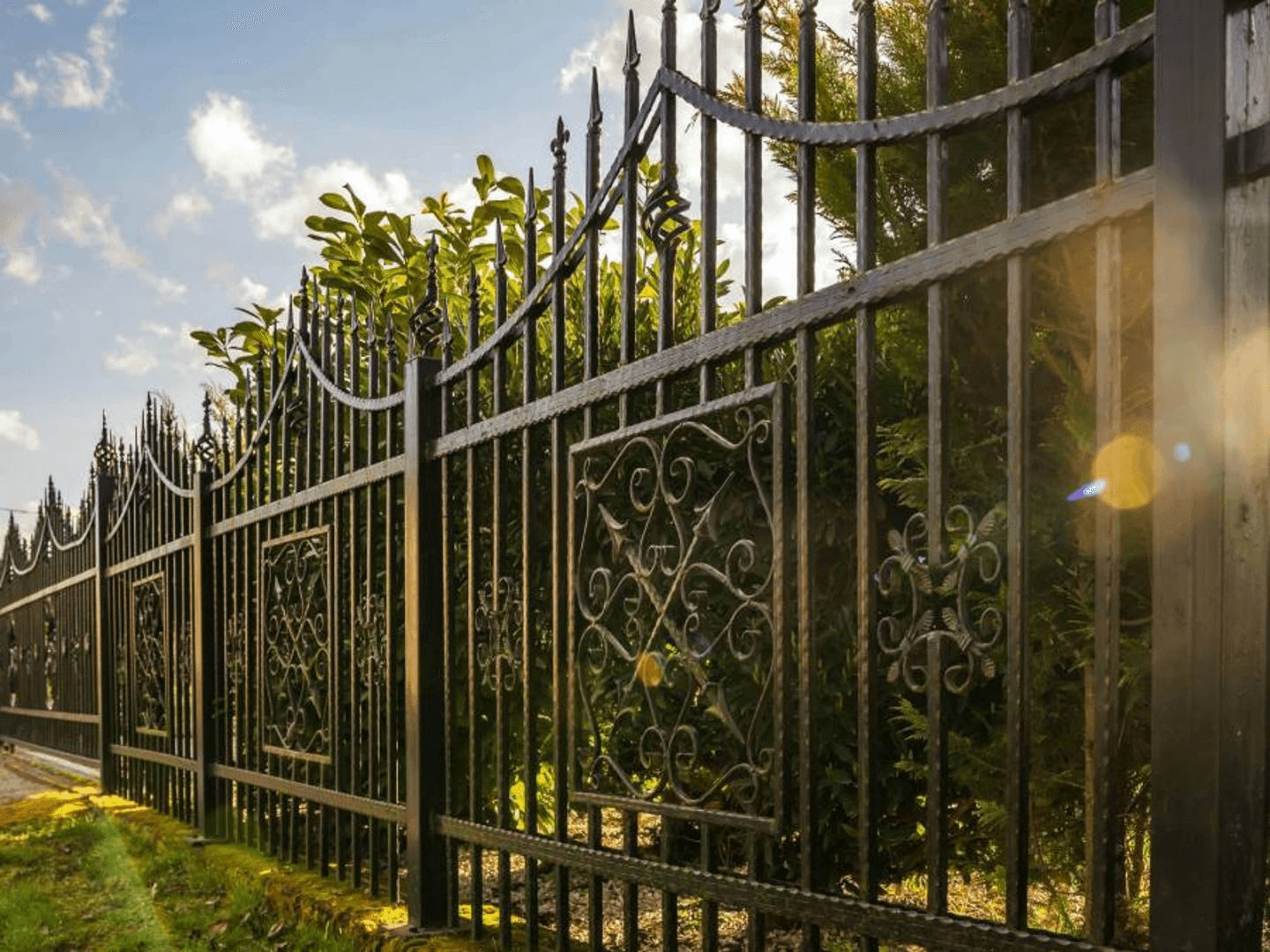 Tall decorative wrought iron fence
